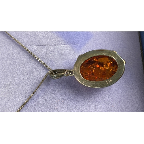 127 - Sterling silver necklace featuring an amber gemstone pendant. Marked 