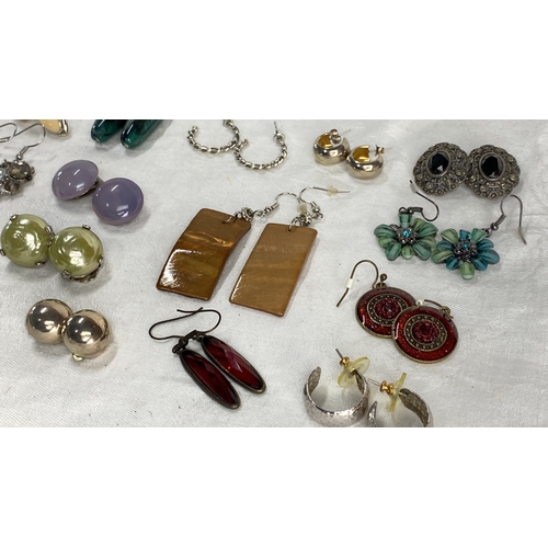 129 - Collection of diverse earrings featuring various gemstones, enamel, and metal designs. Styles includ... 