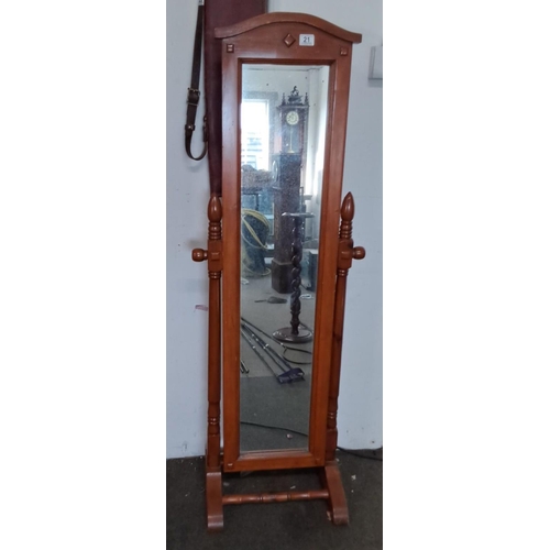 21 - Cheval mirror in polished wood, featuring turned supports and decorative top finial.