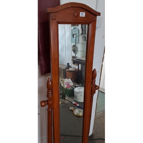 21 - Cheval mirror in polished wood, featuring turned supports and decorative top finial.