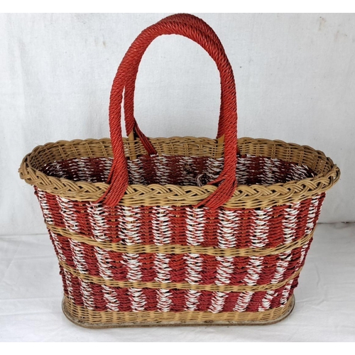 25 - Woven basket features red, white, and natural tones with braided handles.