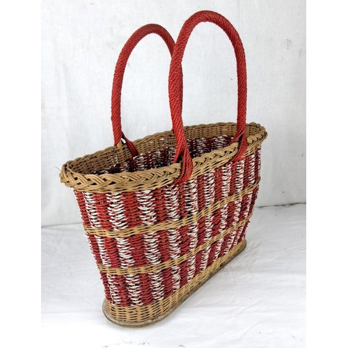 25 - Woven basket features red, white, and natural tones with braided handles.