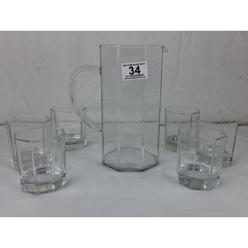 34 - Antique glass pitcher with six matching hexagonal tumblers.