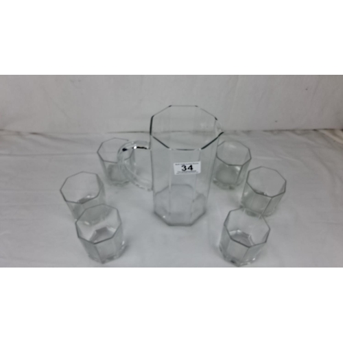 34 - Antique glass pitcher with six matching hexagonal tumblers.