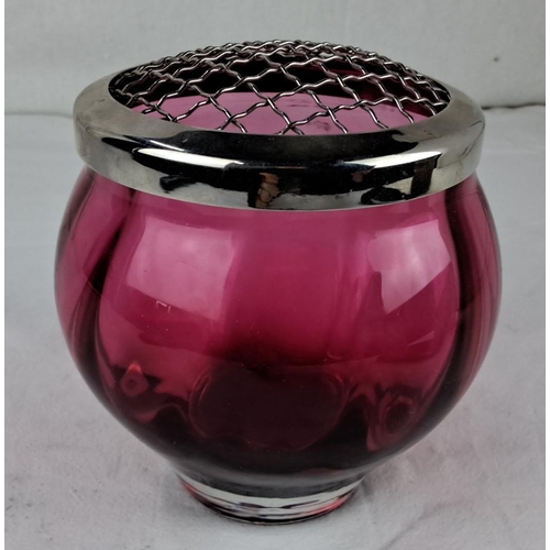 42 - Cranberry glass vase with silver-tone metal flower frog, featuring a rounded shape and grid top desi... 