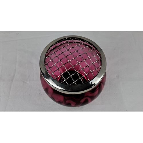 42 - Cranberry glass vase with silver-tone metal flower frog, featuring a rounded shape and grid top desi... 