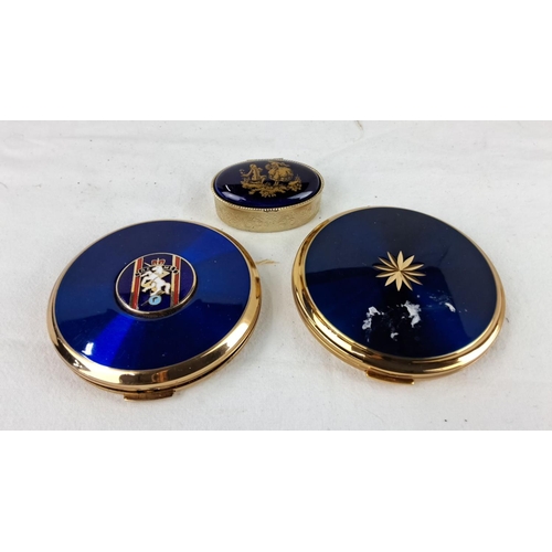 57 - Two vintage Stratton compacts in gold tones feature intricate blue enamel designs and include one sm... 