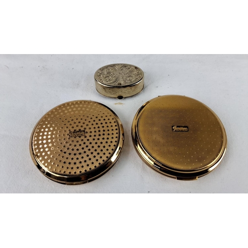 57 - Two vintage Stratton compacts in gold tones feature intricate blue enamel designs and include one sm... 