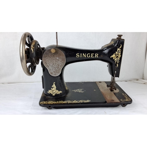 61 - Vintage Singer sewing machine, black with gold floral detailing from the early 20th century.