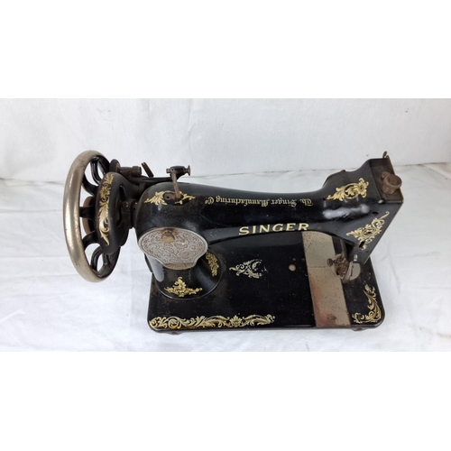 61 - Vintage Singer sewing machine, black with gold floral detailing from the early 20th century.