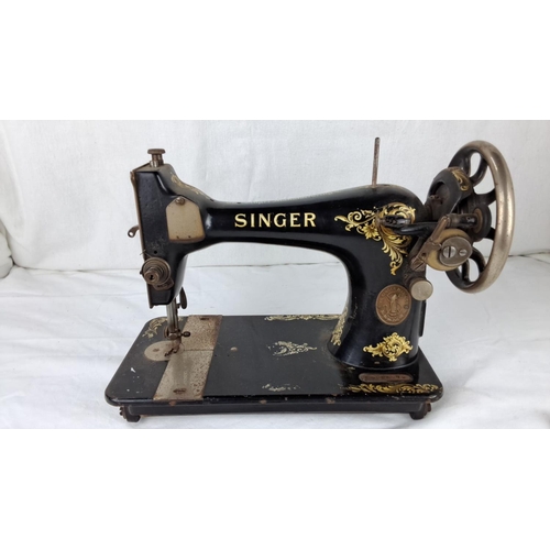 61 - Vintage Singer sewing machine, black with gold floral detailing from the early 20th century.