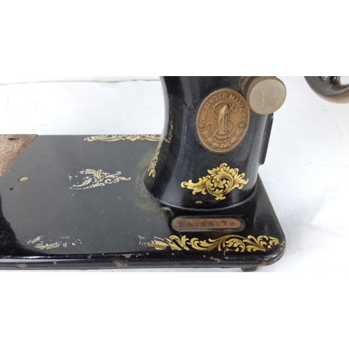 61 - Vintage Singer sewing machine, black with gold floral detailing from the early 20th century.