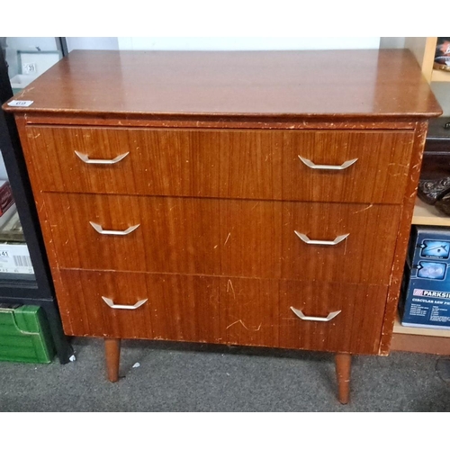 69 - Mid-Century Modern teak veneer chest of drawers with tapered legs and metal handles.