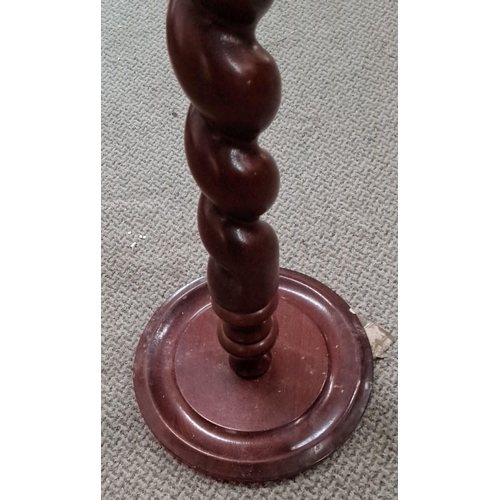 7 - Mahogany plant stand features a barley twist design, round top, and base.