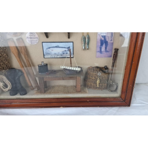 73 - Shadow box features vintage fishing memorabilia, including oars, a net, and a 1927 Minnesota fishing... 