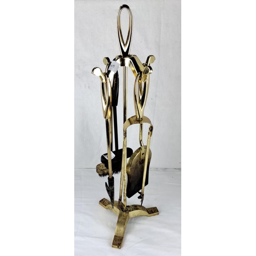 8 - Brass four-piece companion set featuring poker, tongs, shovel, and brush on a stand.