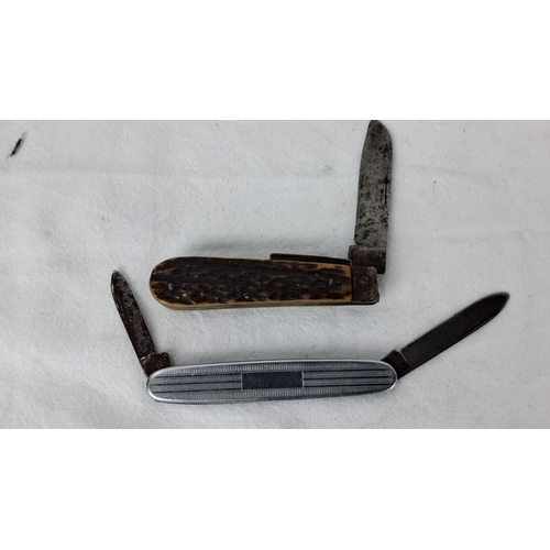 88 - Two vintage pocket knives: one with a bone handle and rustic design, the other with an engraved meta... 