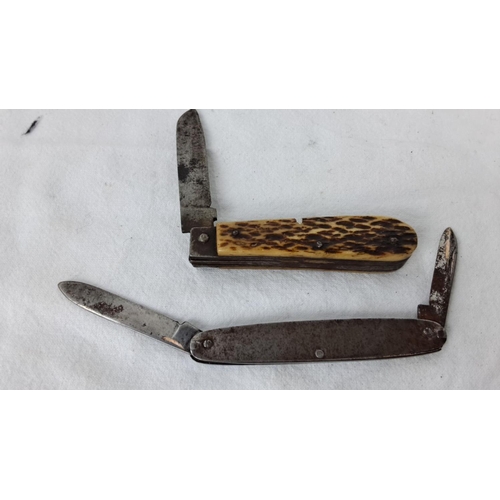 88 - Two vintage pocket knives: one with a bone handle and rustic design, the other with an engraved meta... 