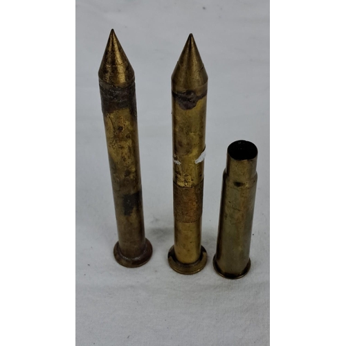 91 - Three vintage brass projectile casings, tapered design with pointed ends.