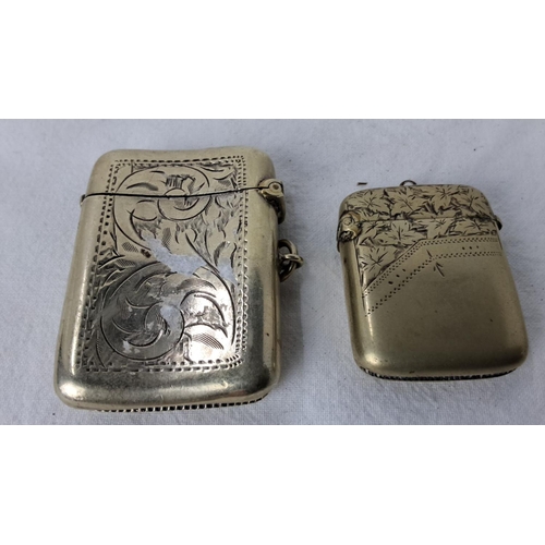 97 - Pair of late 19th-century engraved vesta cases, showcasing ornate floral and geometric patterns. Inc... 