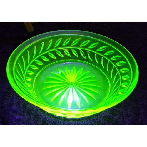 439 - Vintage uranium glass collection features a luminous green bowl under UV light with intricate cut pa... 