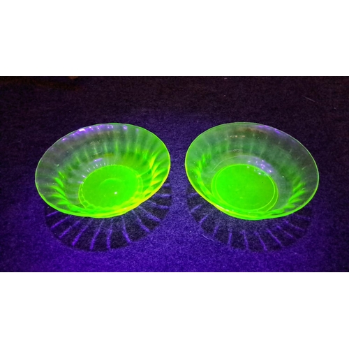 439 - Vintage uranium glass collection features a luminous green bowl under UV light with intricate cut pa... 