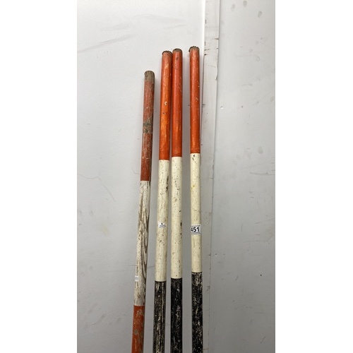 451 - Set of four vintage surveyor's staffs made of painted wood with metal tips, colored in orange and wh... 