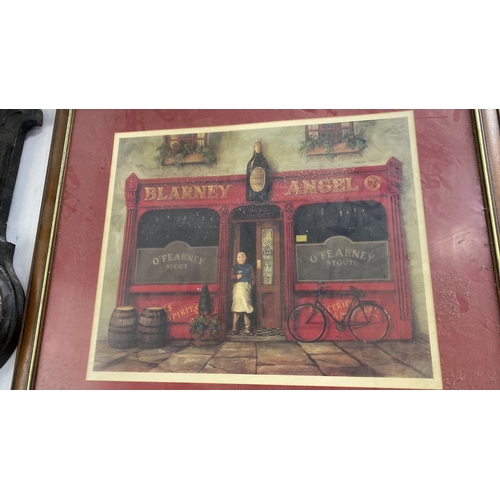 452 - Large Framed print of the Blarney Angel pub, featuring a vibrant street scene. Set in a wooden frame... 