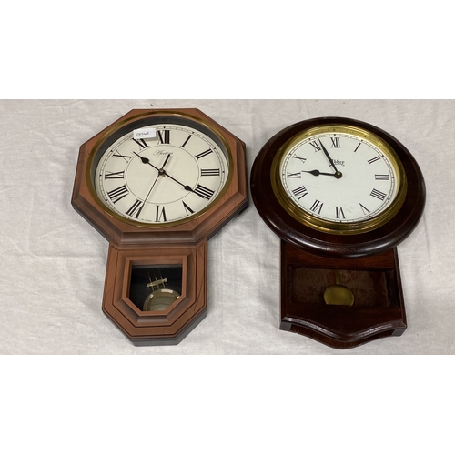 464 - Two English wall clocks, including Acctim with Roman numerals, pendulum window, and Abbey design, ro... 