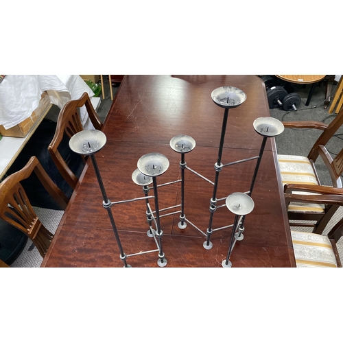 472 - Contemporary wrought iron multi-tiered candle holder with geometric design.