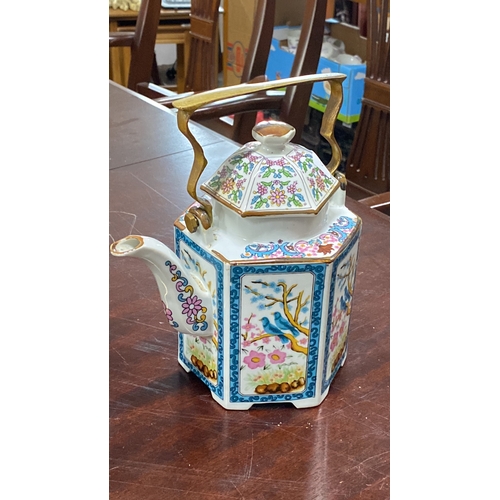 473 - Trio of teapots including a brown ceramic piece with yellow detail, a cobalt blue floral teapot with... 