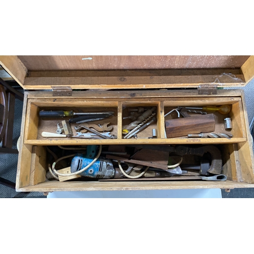 481 - Vintage wooden toolbox with assorted hand tools, including a saw, drill bits, and a screwdriver.