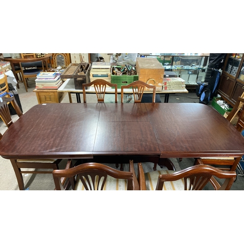 485 - Mahogany dining table with six chairs, featuring upholstered seats and classic carved backrests.