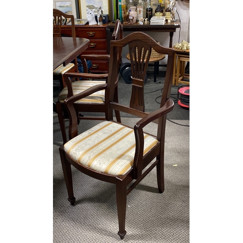 485 - Mahogany dining table with six chairs, featuring upholstered seats and classic carved backrests.