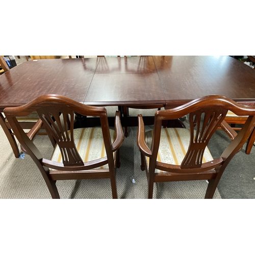 485 - Mahogany dining table with six chairs, featuring upholstered seats and classic carved backrests.