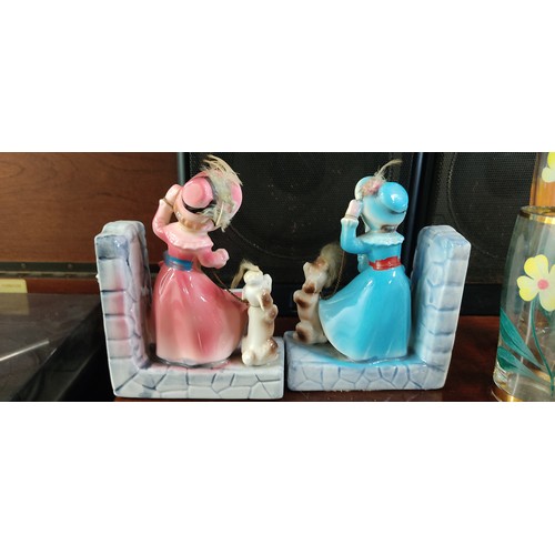 450 - Twin porcelain bookends feature Victorian-style children with dogs, delicately hand-painted with viv... 