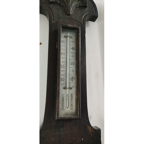 453 - Victorian oak wall barometer with thermometer, featuring aneroid dial. Decorative carving, dual scal... 