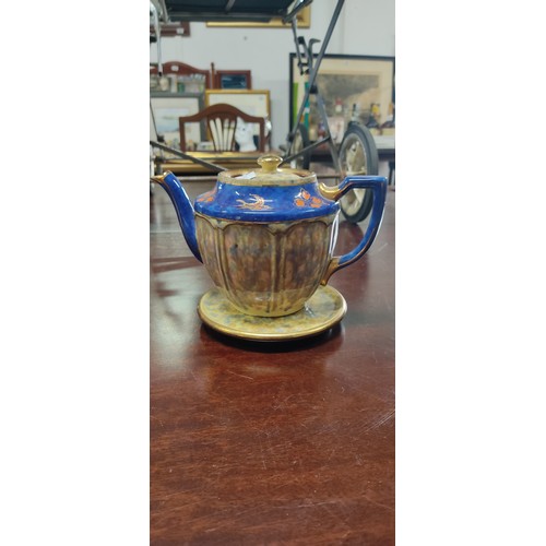 473 - Trio of teapots including a brown ceramic piece with yellow detail, a cobalt blue floral teapot with... 