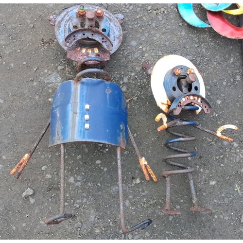 15 - Recycled metal sculptures include two figures with colorful gear elements and a vibrant pinwheel.