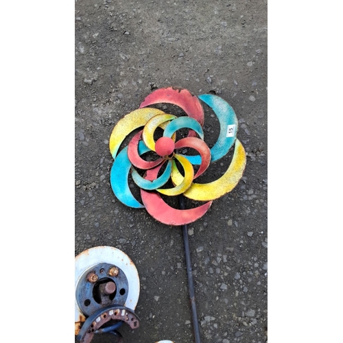 15 - Recycled metal sculptures include two figures with colorful gear elements and a vibrant pinwheel.