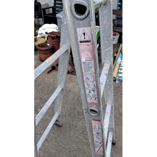 20 - Pair of aluminum extension ladders. Durable construction with safety locks.