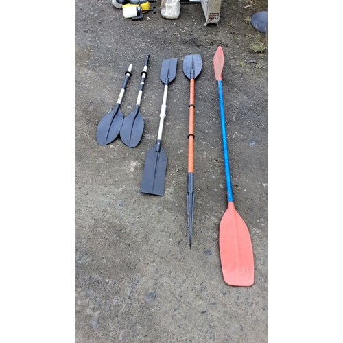 3 - Five assorted paddles, mixed materials and styles. Includes black dual-blade, orange and blue single... 