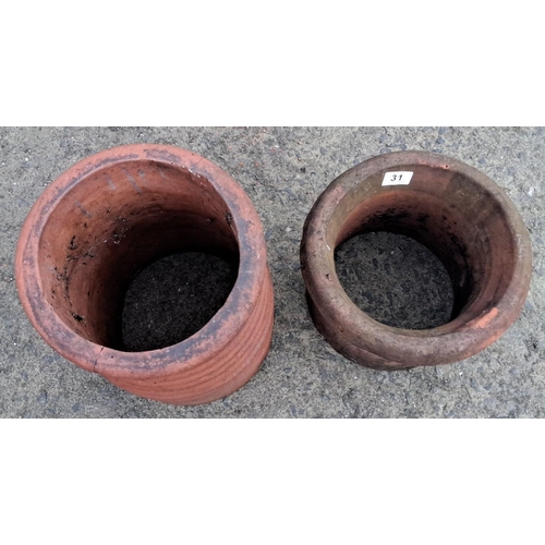 31 - Pair of vintage terracotta chimney pots, tall and ribbed. Rustic charm with natural patina.