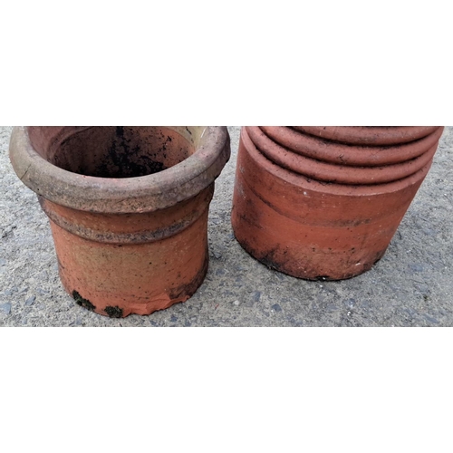 31 - Pair of vintage terracotta chimney pots, tall and ribbed. Rustic charm with natural patina.