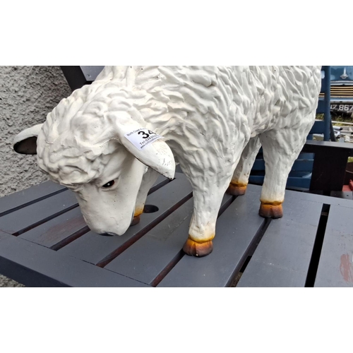 34 - Painted ceramic sheep figurine in a grazing pose.