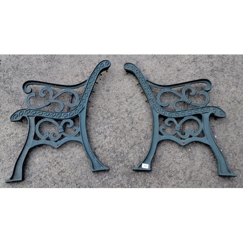 39 - Pair of ornate cast iron bench ends with scroll design.