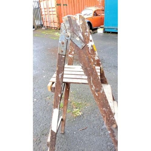 56 - Wooden vintage step ladder with metal hinges, featuring four steps.