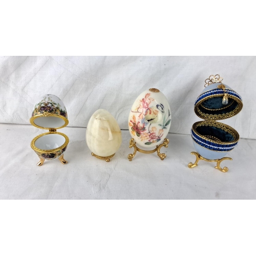 65 - Set of four decorative egg trinket boxes feature floral and bird motifs, ornate hinged openings with... 