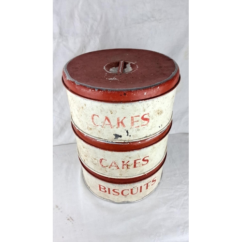 68 - Stacking cake and biscuit tins, distressed white and red paint, from the mid-20th century. Three sec... 