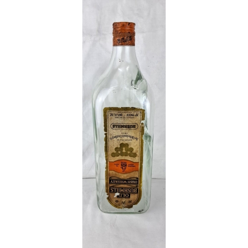 71 - Vintage Bushmills Old Whiskey bottle, featuring original label and distinct Irish branding. A piece ... 